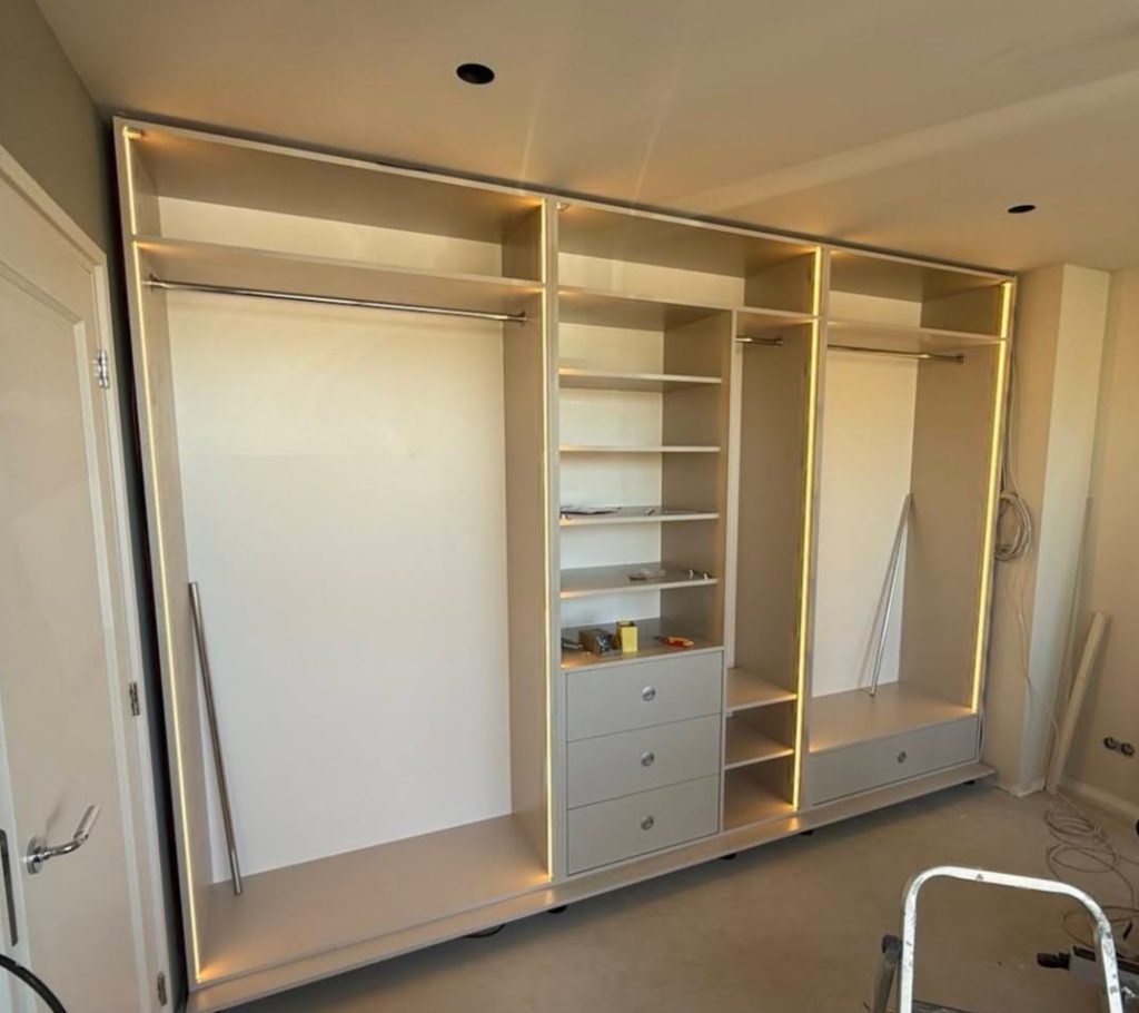 Built-in white closet with integrated lighting